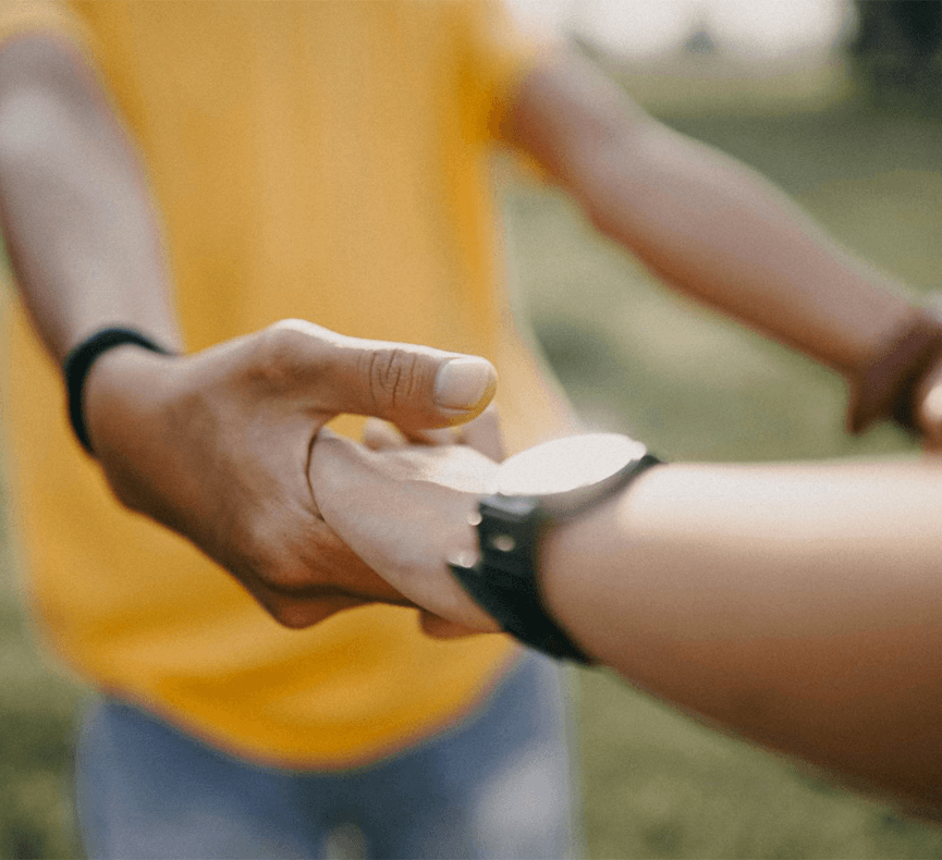 Two people holding hands